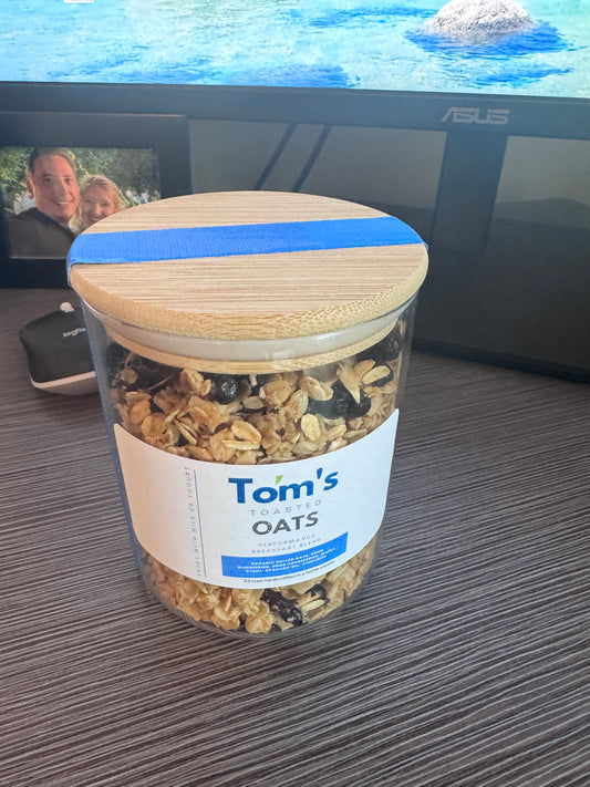 Limited Edition 12 oz Tom's Toasted Oats. Reusable glass jar with bamboo lid. Gift edition.