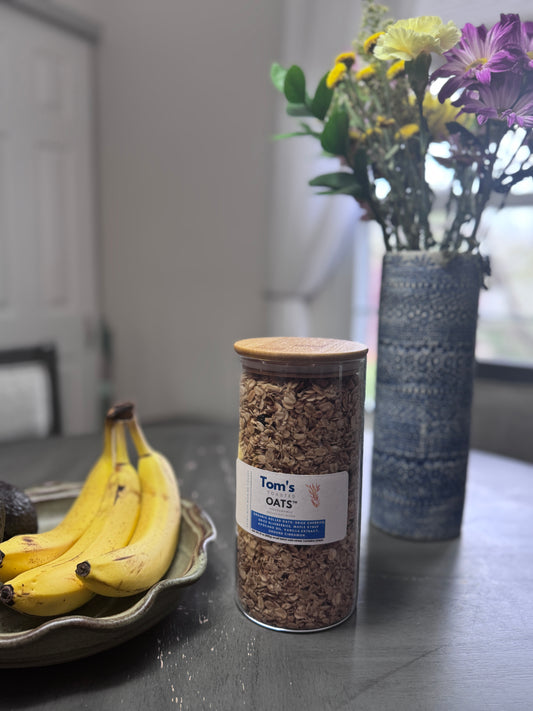 21 oz Weekend Edition Breakfast Oats. Open glass jar with bamboo lid for countertop placement.